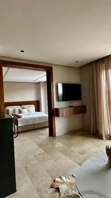 a bedroom with a bed and a flat screen tv at The Hidden Secret in Casablanca