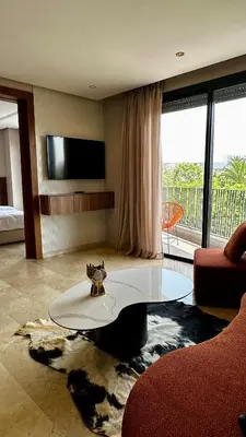 a living room with a coffee table and a large window at The Hidden Secret in Casablanca