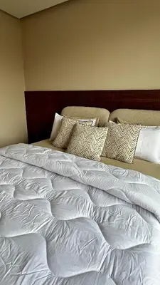 a large white bed with pillows on top of it at The Hidden Secret in Casablanca
