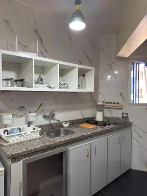 a kitchen with a sink and a counter top at Appartement au centre ville pour les mariés seulement in Rabat