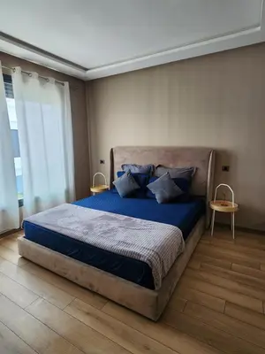 a bedroom with a large bed with blue sheets and pillows at Seaside, Infinity Pools, Gym, Games, Wifi in Tamaris