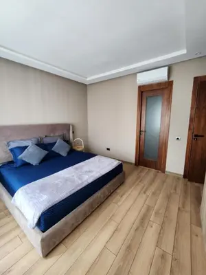 a bedroom with a large bed and a wooden floor at Seaside, Infinity Pools, Gym, Games, Wifi in Tamaris