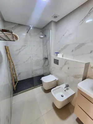 a bathroom with a sink and a toilet and a shower at Seaside, Infinity Pools, Gym, Games, Wifi in Tamaris