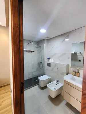 a bathroom with a sink and a toilet and a shower at Seaside, Infinity Pools, Gym, Games, Wifi in Tamaris