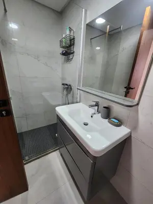 a white bathroom with a sink and a shower at Seaside, Infinity Pools, Gym, Games, Wifi in Tamaris
