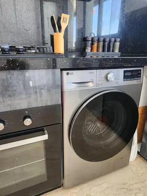 a washing machine sitting next to a stove in a kitchen at Seaside, Infinity Pools, Gym, Games, Wifi in Tamaris