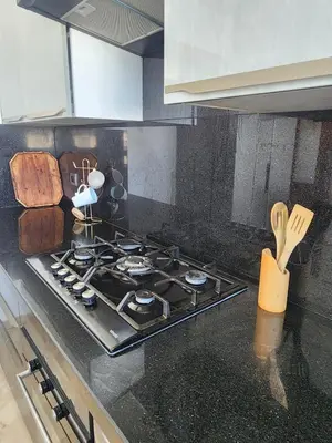 a stove top oven in a kitchen with wooden utensils at Seaside, Infinity Pools, Gym, Games, Wifi in Tamaris