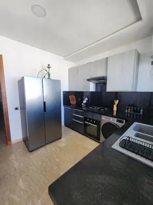 a kitchen with a stainless steel refrigerator and a stove at Seaside, Infinity Pools, Gym, Games, Wifi in Tamaris