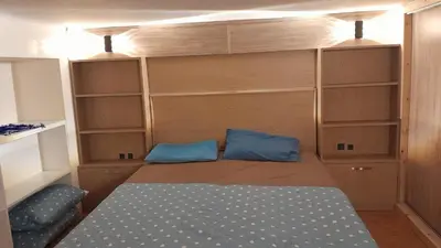 a small room with a bed and some shelves at Studio sympa in Casablanca