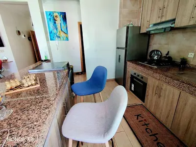 a kitchen with two chairs and a counter top at appartement avec piscines in Mansouria
