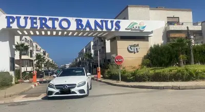 a white car parked in front of a store at Puerto Banus in Mansouria