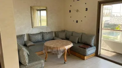 a living room with a couch and a table at Puerto Banus in Mansouria