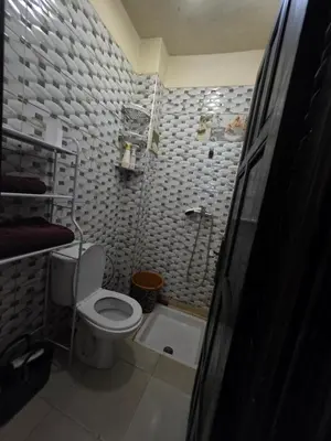 a small bathroom with a toilet and a shower at Appartement souka fitness in Bouznika