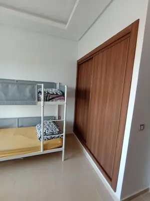 a room with a closet and a wooden door at Charming appartement in Bouznika in Bouznika