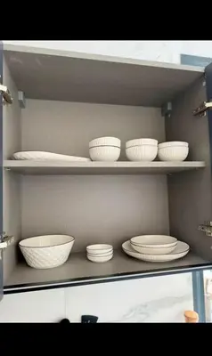 a shelf with white bowls and plates on it at Stay luxe in Casablanca