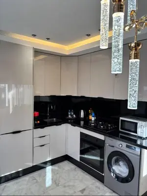 a kitchen with white cabinets and a washing machine at Stay luxe in Casablanca