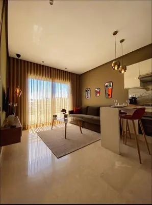 a kitchen and living room with a couch and a table at Concept Studio-valfleuri in Casablanca