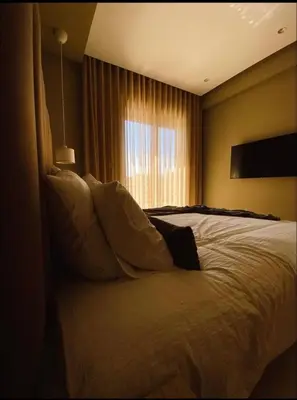 a bedroom with a large bed with a window at Concept Studio-valfleuri in Casablanca