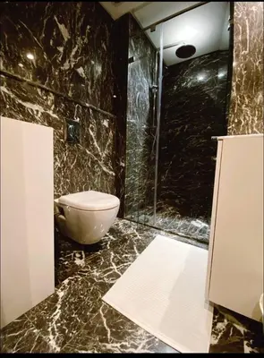 a black marble bathroom with a toilet and a shower at Concept Studio-valfleuri in Casablanca