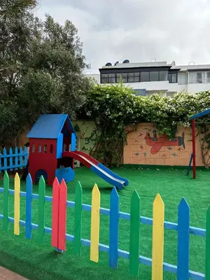 a playground with a colorful fence and a slide at Casa Amy in Mohammedia