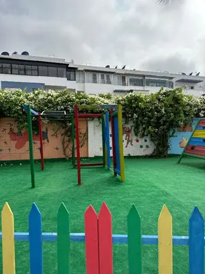 a playground with colorful posts and a fence at Casa Amy in Mohammedia