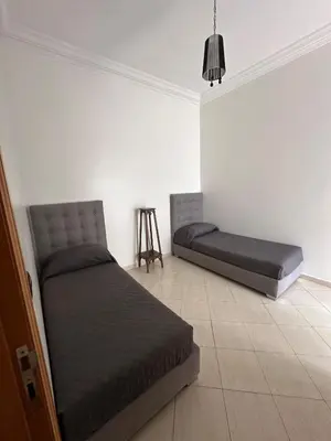 two beds sitting in a room with at Casa Amy in Mohammedia