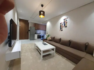 a living room with a couch and a table at Studio Parc Mohammedia in Mohammedia