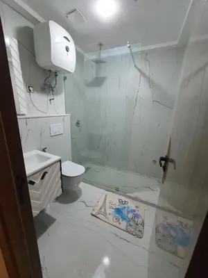a bathroom with a shower and a toilet and a sink at Studio Parc Mohammedia in Mohammedia