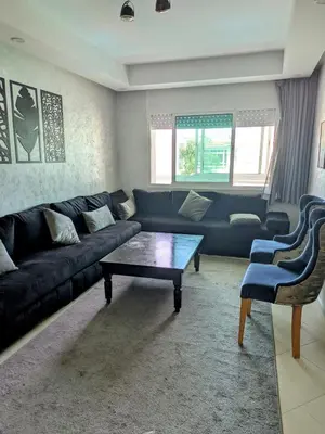 a living room with a couch and a coffee table at Appartement en bord de mer à Harhoura in Temara
