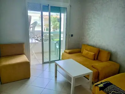 a living room with a couch and a table at Appartement en bord de mer à Harhoura in Temara