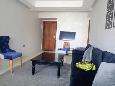 a living room with a couch and a coffee table at Appartement en bord de mer à Harhoura in Temara