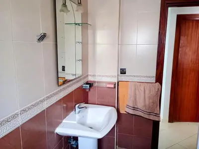 a bathroom with a sink and a mirror at Appartement en bord de mer à Harhoura in Temara