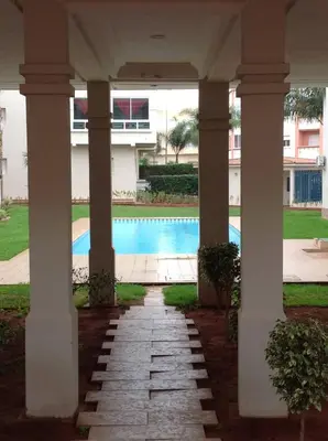 a view of a swimming pool from the porch of a building at Appartement en bord de mer à Harhoura in Temara