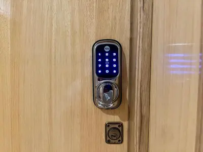 a remote control attached to a wooden door at Rihla Stays - Anfa City in Casablanca