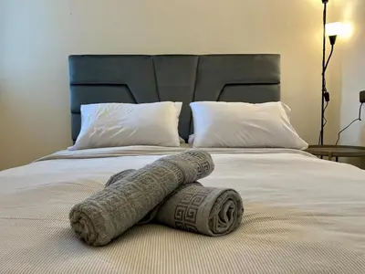 a blanket laying on top of a bed at Casablanca Central Suites - Casa Voyageurs in Casablanca