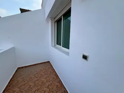 a room with a window and a brick floor at Casablanca Central Suites - Casa Voyageurs in Casablanca