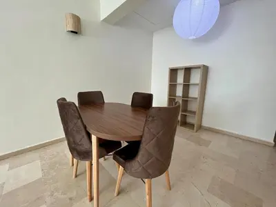 a wooden table with four chairs in a room at Casablanca Central Suites - Casa Voyageurs in Casablanca