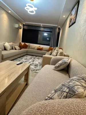a living room with two couches and a flat screen tv at Appart a 1 minutes de la plage in Casablanca