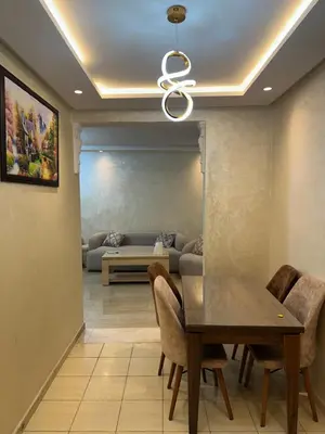 a dining room with a table and a couch at Appart a 1 minutes de la plage in Casablanca