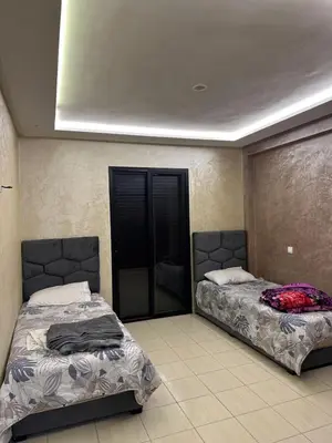 two beds sitting next to each other in a room at Appart a 1 minutes de la plage in Casablanca