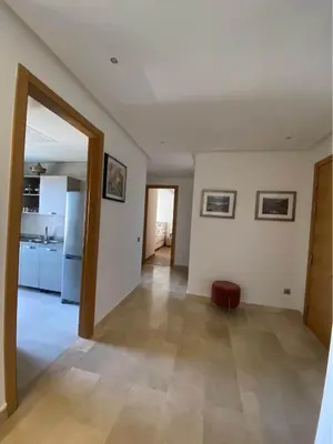 a living room with a door open to a kitchen at Résidence yassmin in Rabat