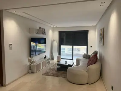 a living room with a couch and a table at Appartement maarif in Casablanca
