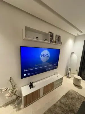 a living room with a nrs tv on a wall at Appartement maarif in Casablanca