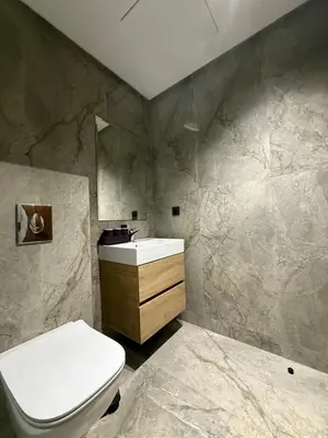 a bathroom with a white toilet and a sink at Appartement maarif in Casablanca