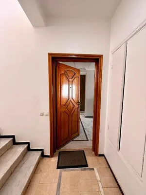 a hallway with a wooden door and stairs at Luxury Apartment Ocean View and Private Beach Ain Diab in Casablanca