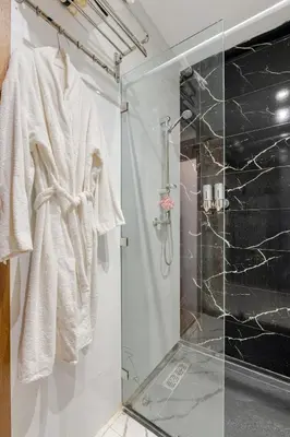 a bathroom with a shower and a glass shower stall at Au Petit Port Balcony & Sea view 5 mn from casa-port in Casablanca