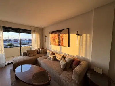 a living room with a couch and a table at Au Petit Port Balcony & Sea view 5 mn from casa-port in Casablanca