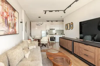 a living room with a couch and a table at Au Petit Port Balcony & Sea view 5 mn from casa-port in Casablanca
