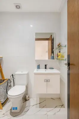 a white bathroom with a toilet and a sink at Au Petit Port Balcony & Sea view 5 mn from casa-port in Casablanca