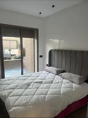a bedroom with a large bed with a large window at Sunset Malaga beach house in Mansouria